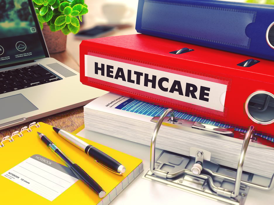Healthcare - Red Office Folder on Background of Working Table with Stationery, Laptop and Reports. Business Concept on Blurred Background. Toned Image. Healthcare - Red Office Folder on Background of Working Table with Stationery, Laptop and Reports. Business Concept on Blurred Background. Toned Image.